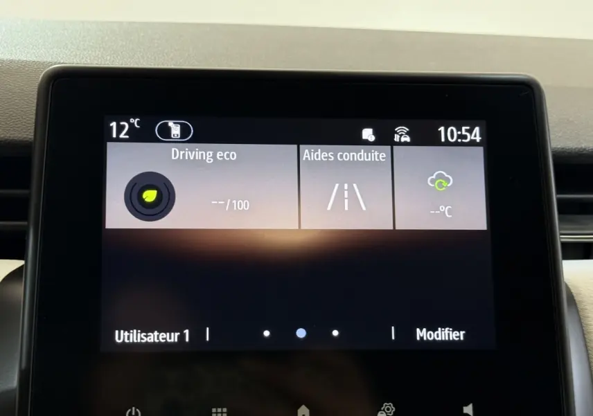 Écran tactile central de la Renault Clio blanc 2023 affichant les aides à la conduite et l’info éco à 10h54.