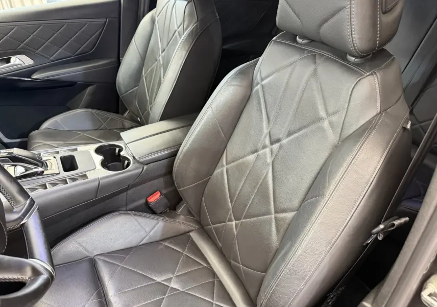 Vue intérieure rapprochée des sièges avant en cuir gris foncé avec surpiqûres losanges du DS7 Crossback 2018.