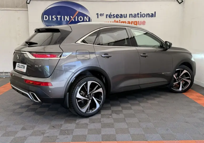 Vue 3/4 arrière droite du DS7 Crossback gris foncé avec jantes alliage bicolores et feux arrière LED distinctifs.