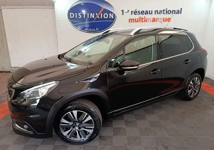 Peugeot 2008 noir en vue de profil côté gauche, avec jantes alliage et rails de toit chromés visibles.