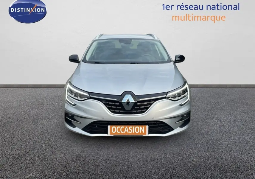 Vue frontale d'une Renault Mégane Break gris Highland Metal avec calandre noire et phares LED allumés.