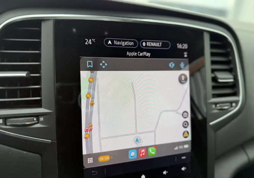 Écran tactile central de la Renault Mégane Break 2024 affichant la navigation Apple CarPlay en intérieur noir.