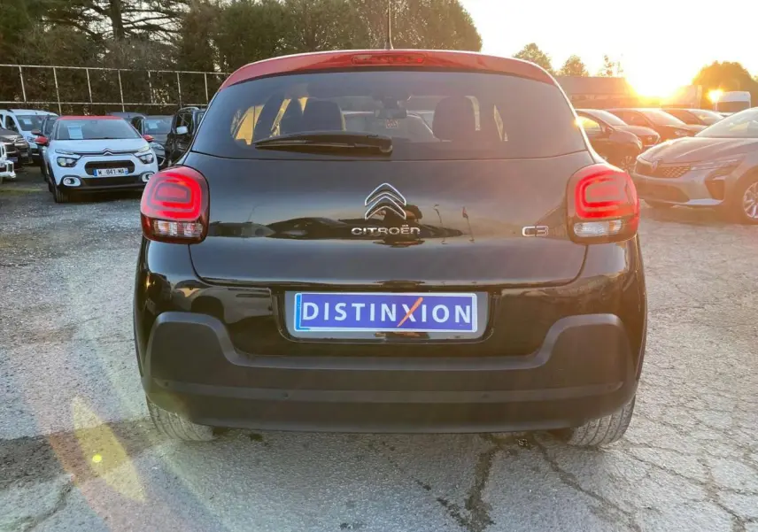 Vue arrière d'une Citroën C3 noire avec toit rouge, feux arrière LED et plaque d'immatriculation Distinxion.