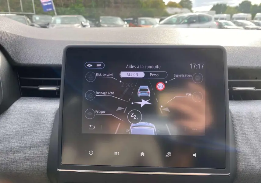 Écran tactile central de la Renault Clio 2025 noir étoilé affichant les aides à la conduite en gros plan intérieur.