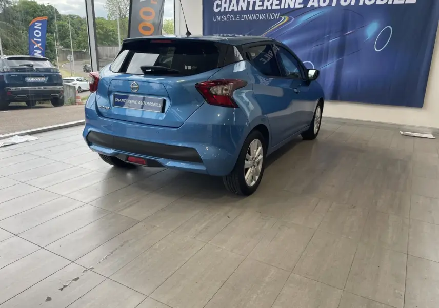 Vue 3/4 arrière droite d'une Nissan Micra IG-T 100 N-Connecta bleu dans un showroom avec logo Chantereine Automobile.
