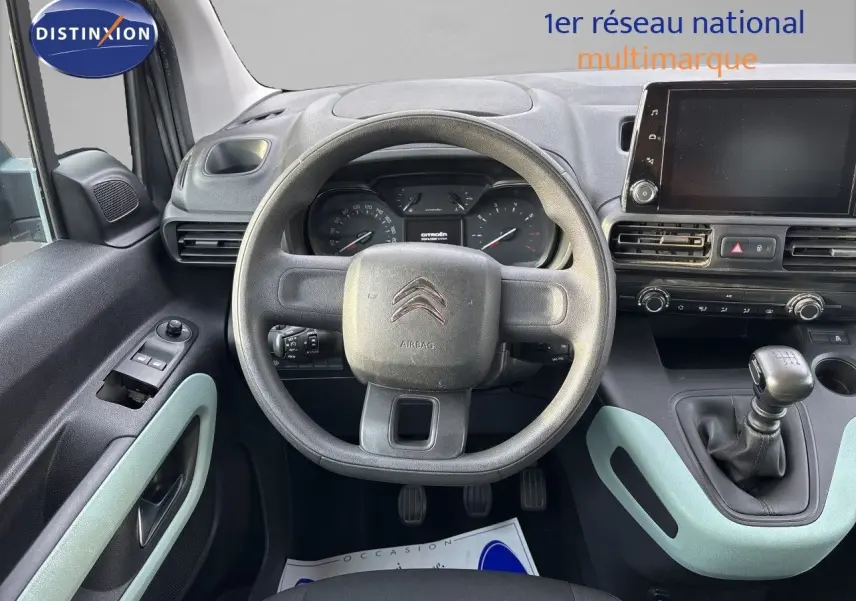 Vue intérieure centrée sur le volant et tableau de bord du Citroën Berlingo Multispace gris platinium avec boîte manuelle.