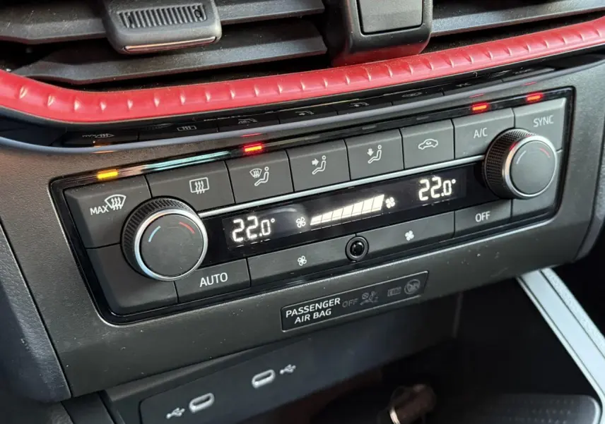 Gros plan sur la commande de climatisation bi-zone digitale avec finition rouge et affichage à 22 degrés dans une SEAT Ibiza 2025.