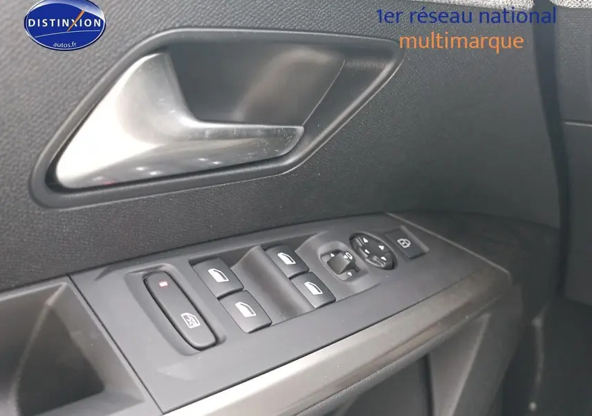 Gros plan sur la commande des vitres et rétroviseurs côté conducteur d’un Peugeot 5008 bleu 2025.