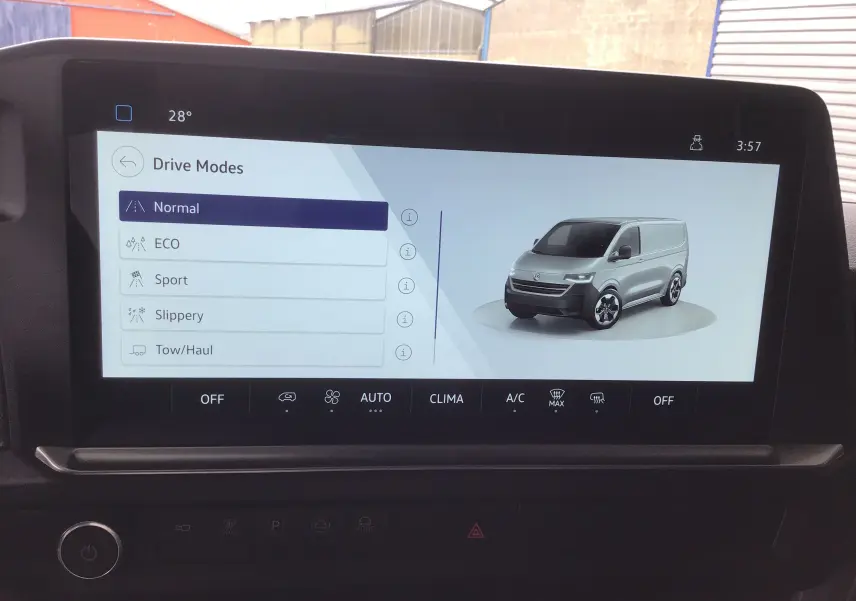 Écran tactile intérieur affichant les modes de conduite avec une image 3D du Volkswagen Transporter T7 gris stone de profil avant droit.