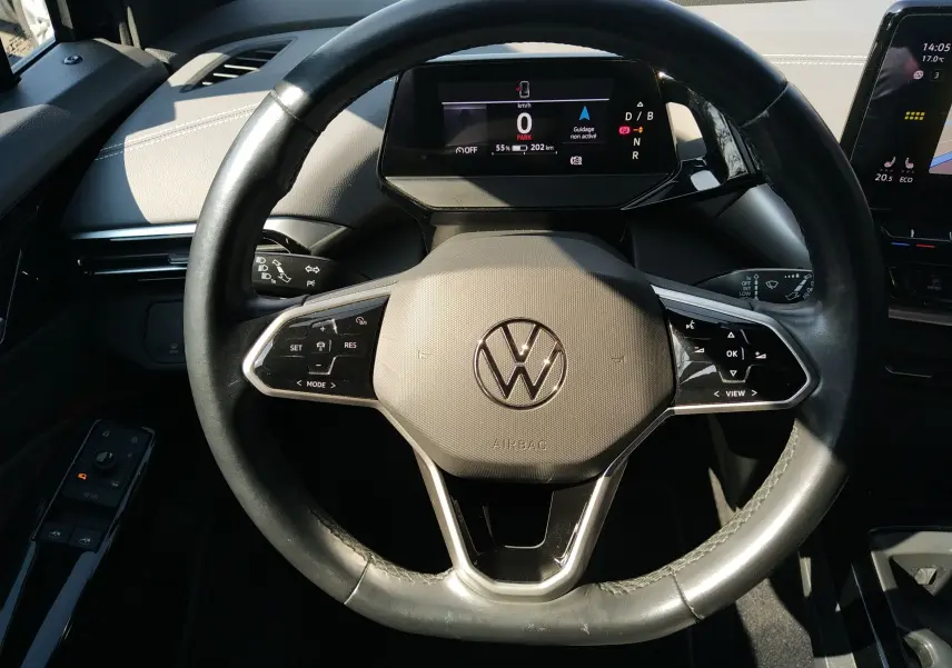 Vue rapprochée du volant noir de la Volkswagen ID.4 2022 avec tableau de bord numérique et commandes intégrées.
