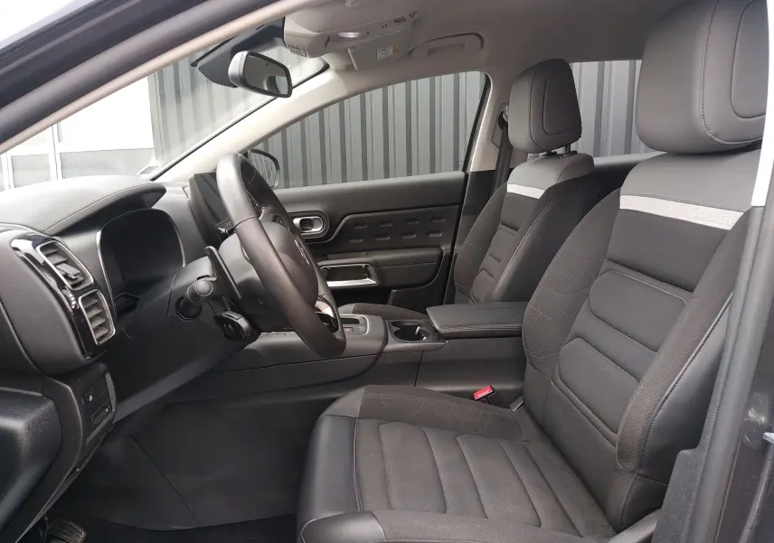 Vue intérieure côté gauche du poste de conduite du Citroën C5 Aircross 2023 avec sièges noirs et tableau de bord moderne.