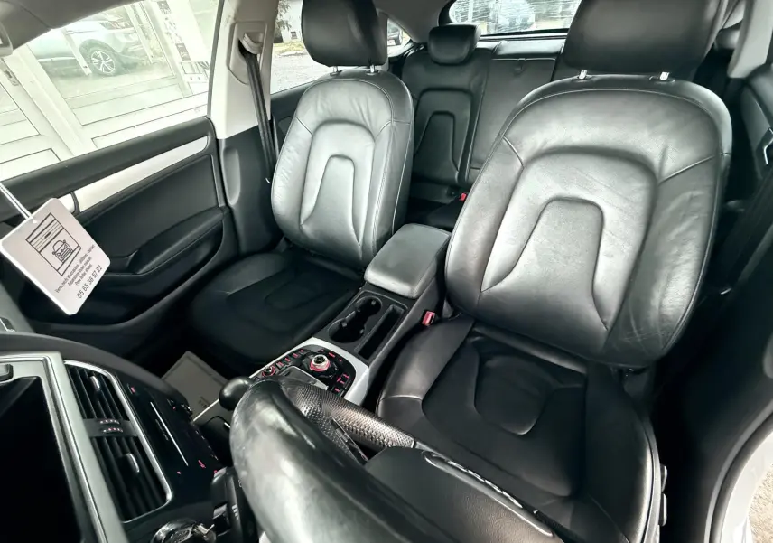 Vue intérieure de l'Audi A5 Sportback 2011 montrant les sièges avant en cuir noir et la console centrale.