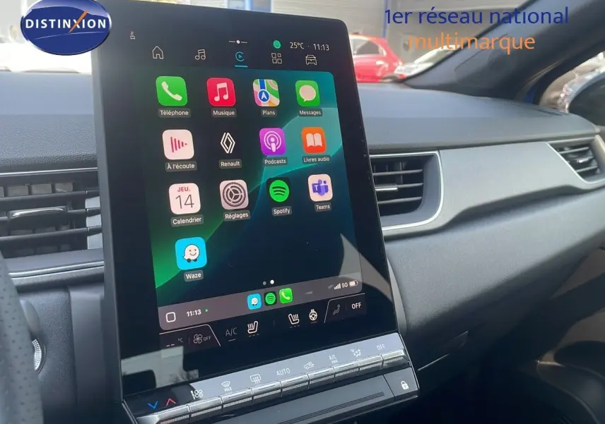 Vue rapprochée de l'écran tactile central du tableau de bord du Renault Captur bleu Iron Metal 2025, affichant les applications connectées.