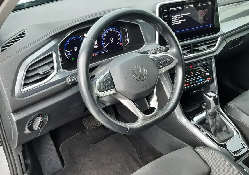 Gros plan sur la roue avant gauche d’un Volkswagen T-Roc gris pyrite avec jante alliage 5 branches doubles.