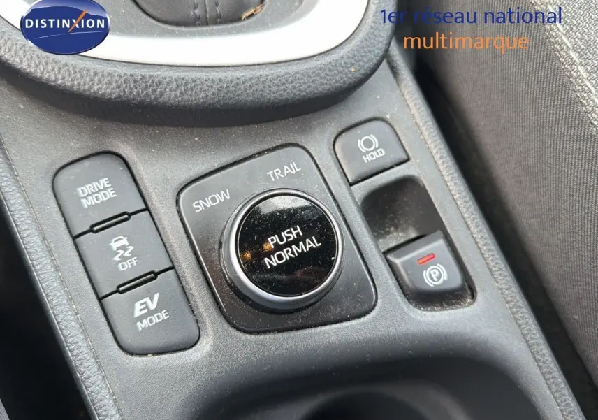 Gros plan sur la console centrale de la Toyota Yaris Cross 116h Design AWD-i avec commandes de modes de conduite en noir.