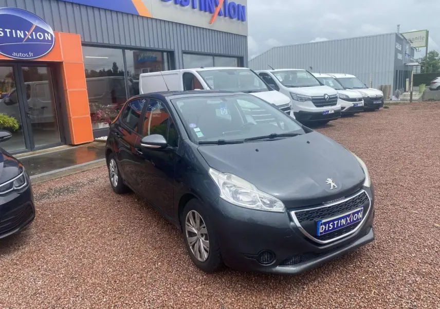 Peugeot 208 gris shark vue 3/4 avant sur parking devant concession Distinxion.