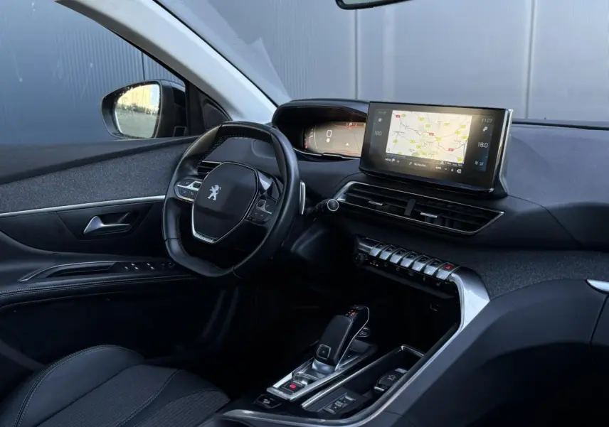 Vue intérieure côté conducteur du Peugeot 5008 2022 avec tableau de bord numérique et écran tactile central affichant la navigation.