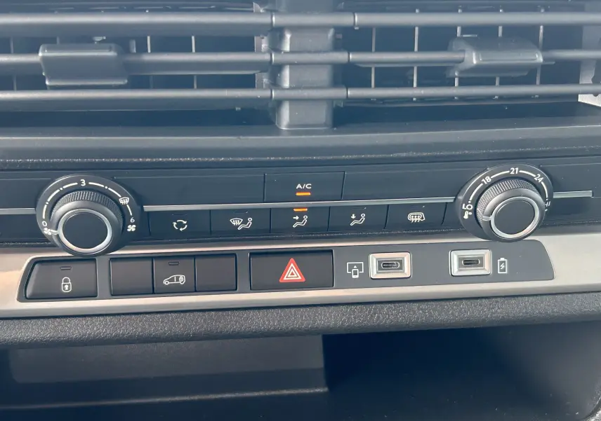 Gros plan sur la console centrale du Citroën Jumpy gris titane 2025, montrant les commandes de climatisation et ports USB.