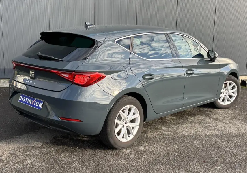 Vue 3/4 arrière droite d'une SEAT Leon bleu Fjord avec feux arrière LED et jantes alliage 16 pouces.