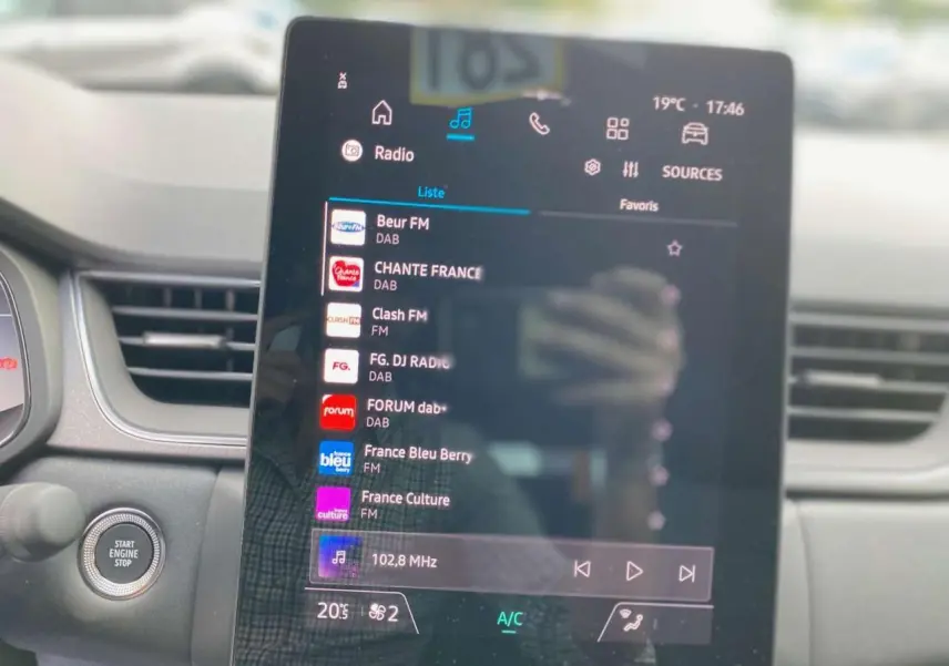 Vue intérieure centrée sur l'écran tactile multimédia du Renault Captur 2025, affichant les stations radio.