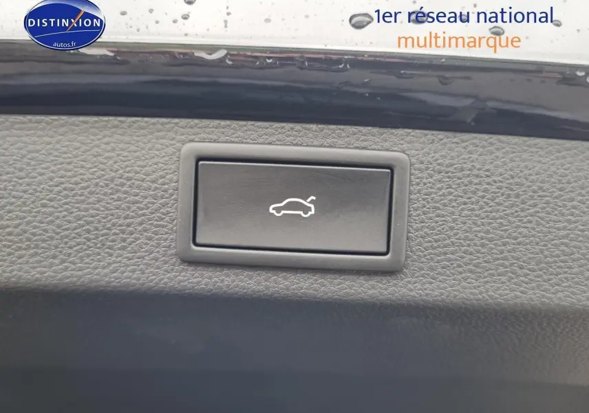 Bouton noir d'ouverture électrique du coffre sur panneau intérieur d'un Skoda Karoq noir 2025.