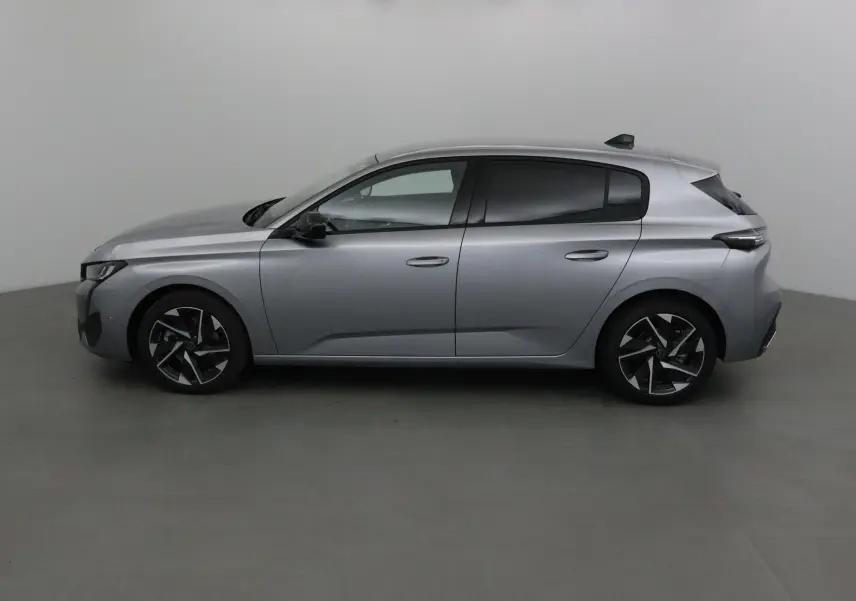 Peugeot 308 gris Artense vue profil côté gauche, mettant en valeur ses jantes alliage et lignes modernes.