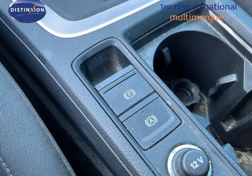 Gros plan sur la console centrale noire de l'Audi Q3 Sportback 35 TDI 2022, montrant les boutons de frein à main et arrêt auto.