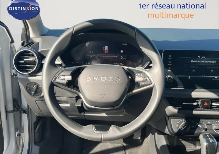 Vue intérieure centrée sur le volant SKODA d'une Fabia 2025 en Reflex Silver Metal avec tableau de bord digital.