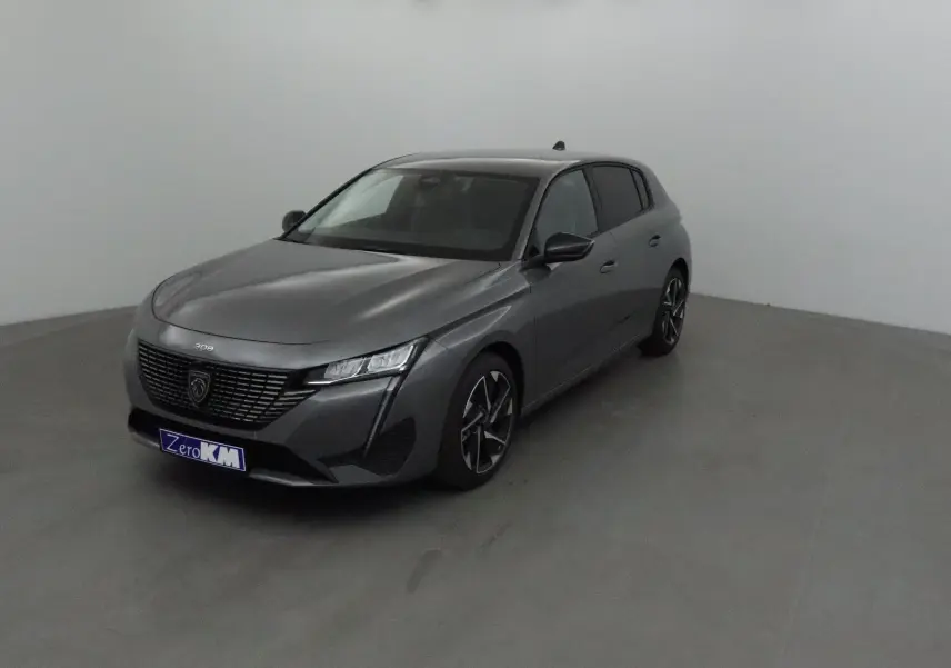 Peugeot 308 gris Sellenium vue 3/4 avant droit dans un studio, avec calandre noire et jantes alliage distinctives.