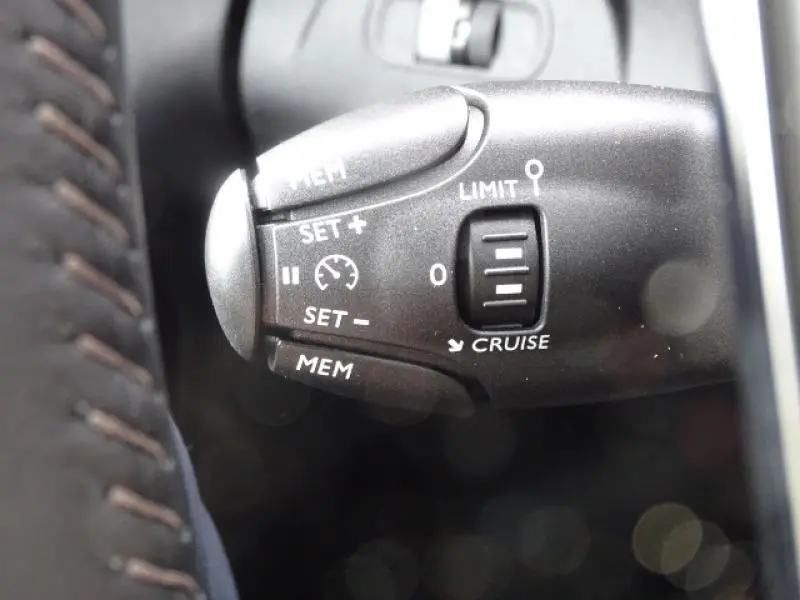 Gros plan sur la commande de régulateur de vitesse du Peugeot Rifter 2019, détails des boutons et inscriptions blanches.