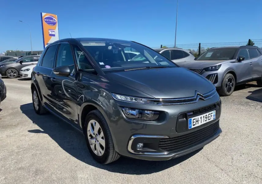 Citroën C4 Picasso gris shark vue 3/4 avant droit, avec feux LED et jantes alliage 16 pouces visibles.