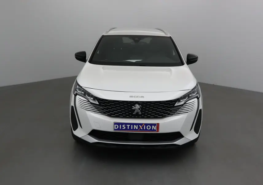Peugeot 5008 blanc nacré vue de face, mettant en valeur sa calandre noire et ses phares LED distinctifs.