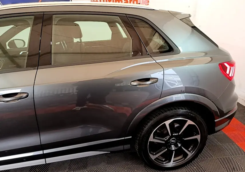 Vue latérale droite sur l'arrière d'un Audi Q3 gris foncé avec jante alliage et feux arrière LED distinctifs.