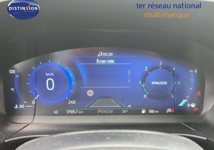 Vue rapprochée du tableau de bord numérique bleu d’un Ford Kuga 2024, affichant vitesse et compte-tours.