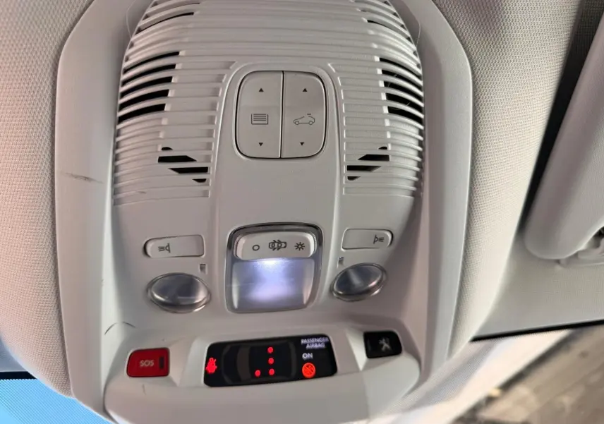 Vue en gros plan du plafonnier blanc nacré du Peugeot 3008 2019 avec boutons d'éclairage et alerte SOS.