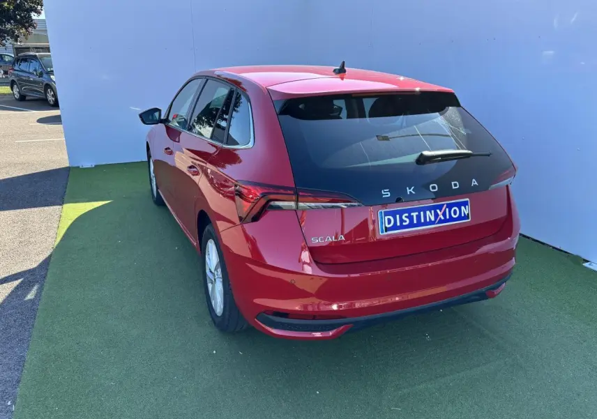 Vue 3/4 arrière droite d'une Skoda Scala rouge Velvet Metal avec feux arrière Full LED et jantes alliage 16 pouces Cortadero Aero.