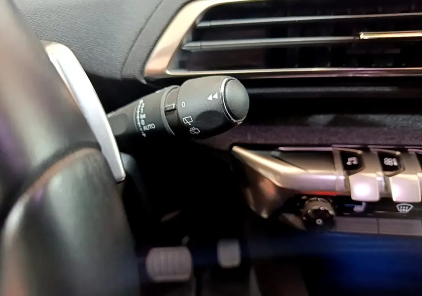Gros plan sur la commande d’essuie-glace côté gauche du tableau de bord gris foncé du Peugeot 3008 gris clair 2020.