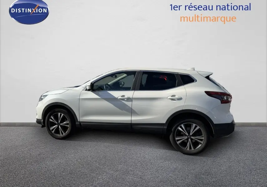 Vue de profil côté gauche d'un Nissan Qashqai blanc nacré avec jantes alliage noires et détails noirs sur bas de caisse.
