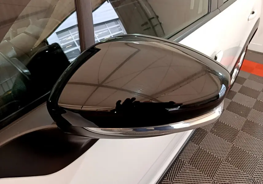 Rétroviseur noir brillant côté conducteur d'une Citroën C3 blanche PureTech 68 BVM Feel vue de près.