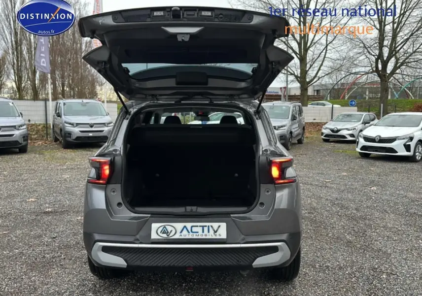 Vue arrière d’un Citroën C3 Aircross gris 2025 avec coffre ouvert et feux arrière allumés.