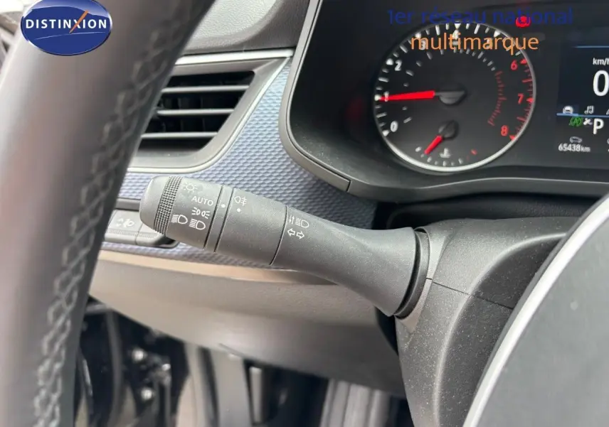 Gros plan sur la manette des feux et clignotants du tableau de bord d'une Renault Arkana noir métal 2022.