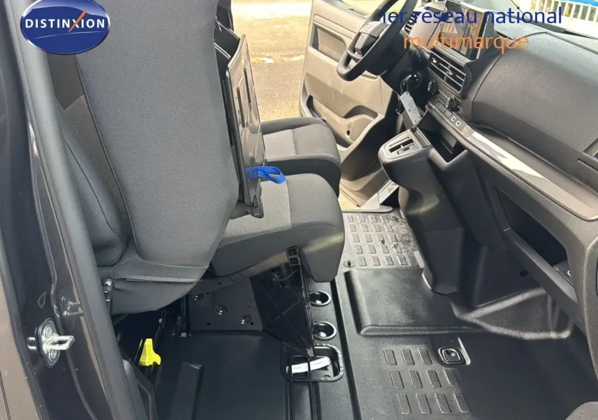 Intérieur avant du Citroën Jumpy Fourgon gris titane, vue côté conducteur avec sièges et tableau de bord visibles.