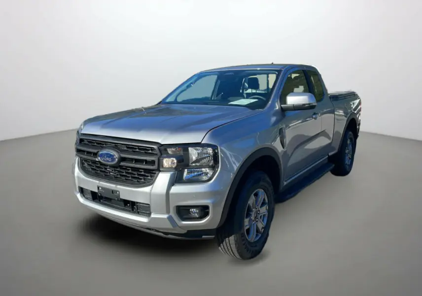 Ford Ranger 2025 gris iconic en 3/4 avant droit, avec calandre noire et cabine Supercab visible côté droit.