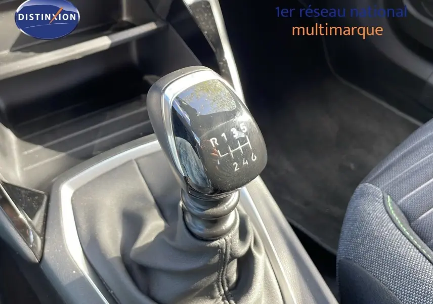 Le levier de vitesses manuel en gros plan dans l'habitacle du Peugeot 2008 bleu Vertigo Metal, avec sellerie tissu noir et gris.