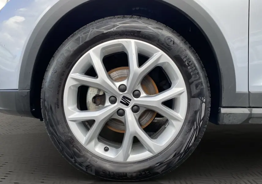 Gros plan sur la roue avant droite d'une SEAT Arona gris silver avec jante alu 17 pouces au design dynamique.