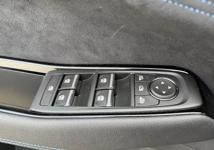 Commande des vitres électriques et réglages des rétroviseurs sur la porte côté conducteur du Renault Austral bleu Iron 2025.