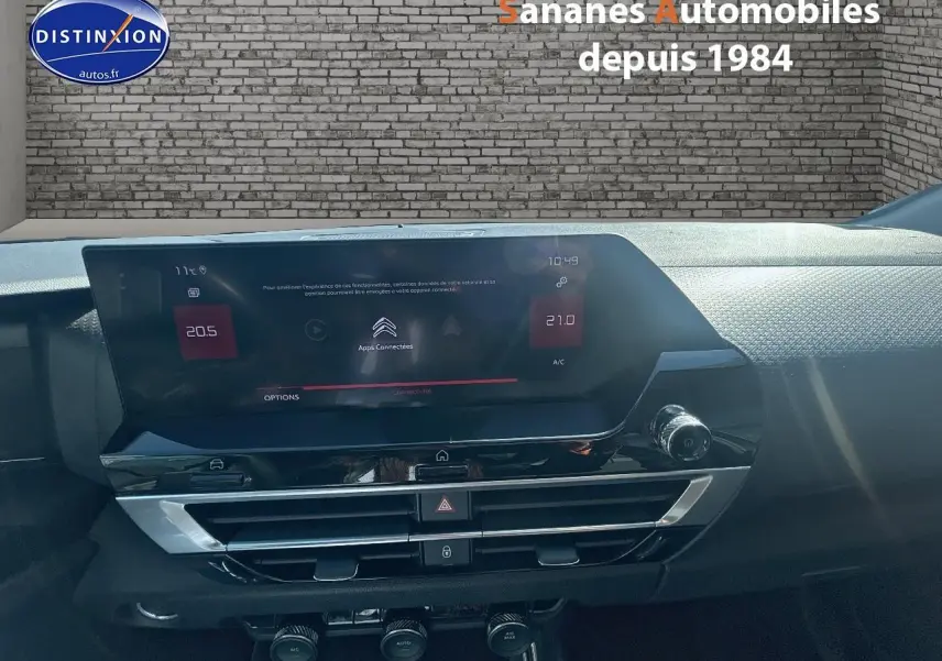 Tableau de bord de Citroën C4 bleu clair 2021, vue frontale centrée sur l’écran tactile et commandes climatisation.