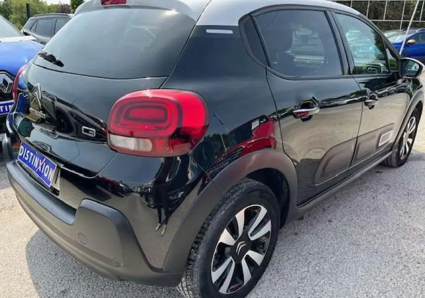 Vue 3/4 arrière droite d'une Citroën C3 noire métal 2023 avec jantes alliage diamantées et vitres surteintées.