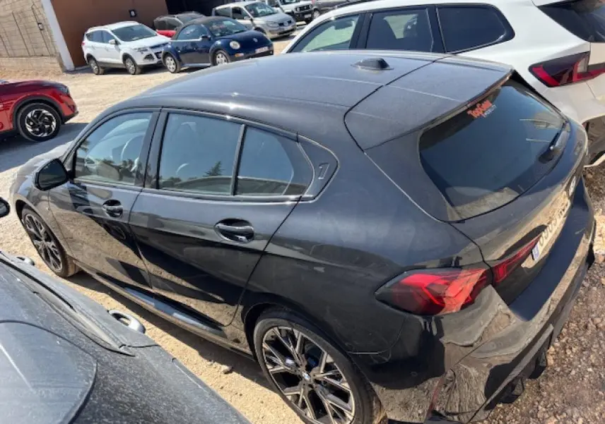 BMW Série 1 118d M Sport noir métal vue 3/4 arrière droit avec jantes alliage et toit panoramique