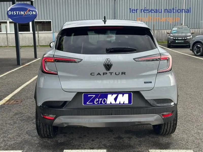 Vue arrière du Renault Captur 1.8 E-Tech hybride 2026 en Gris Rafale avec détails noirs et feux LED distinctifs.